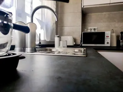 a kitchen counter with a sink and a microwave at Estudio Mar Azul Grupo AC Gestion in Cádiz