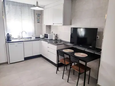 a kitchen with a small table and chairs in it at Estudio Mar Azul Grupo AC Gestion in Cádiz