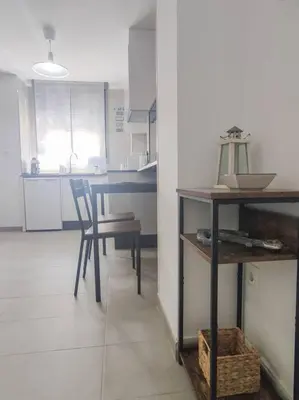 a kitchen with a table and a chair in a room at Estudio Mar Azul Grupo AC Gestion in Cádiz