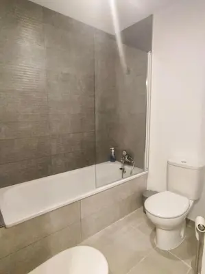 a bathroom with a toilet and a shower with a tub at Estudio Mar Azul Grupo AC Gestion in Cádiz