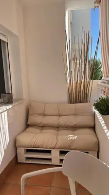 a living room with a couch and a chair at Apartamento Any en Rota in Rota