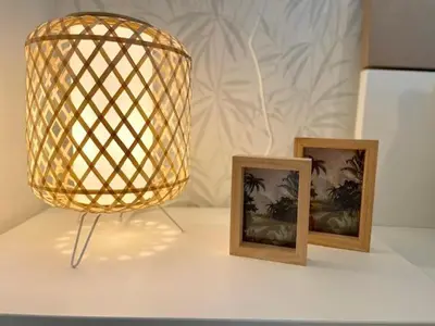 a lamp and two pictures on a table at GATU PREMIUM El Viñedo, centro, parking, aire acc, terraza, piscina comun