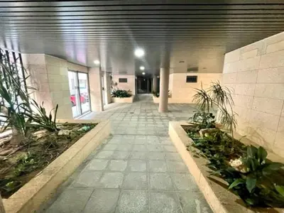 an empty hallway in a building with plants at GATU PREMIUM El Viñedo, centro, parking, aire acc, terraza, piscina comun