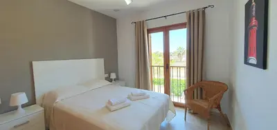 a bedroom with a bed with two towels on it at Appartement à 850 m de la plage de la Barrosa in Chiclana de la Frontera