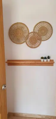 three baskets on a shelf on a wall at Appartement à 850 m de la plage de la Barrosa in Chiclana de la Frontera