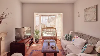 a living room with a couch and a tv at Villa Lola 14 Chiclana de la Frontera by Ruralidays in Chiclana de la Frontera