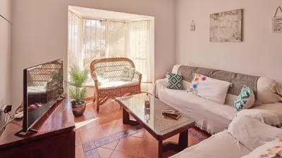 a living room with a couch and a table at Villa Lola 14 Chiclana de la Frontera by Ruralidays in Chiclana de la Frontera