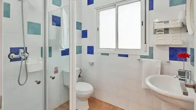 a bathroom with a toilet and a sink and a window at Villa Bananera Conil de la Frontera by Ruralidays in Conil de la Frontera