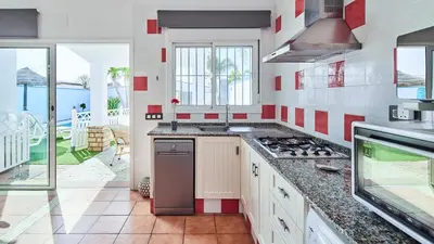 a kitchen with a stove top oven next to a balcony at Villa Yuca Conil de la Frontera by Ruralidays in Conil de la Frontera