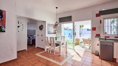 a kitchen and dining room with a table and chairs at Villa Yuca Conil de la Frontera by Ruralidays in Conil de la Frontera