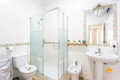 a bathroom with a toilet and a sink and a shower at Corralon de los Carros by Cadiz Time in Cádiz