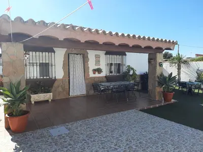 a patio of a house with a table and chairs at Casa LA PEPA in Chiclana de la Frontera