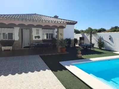 a house with a swimming pool in front of it at Casa LA PEPA in Chiclana de la Frontera