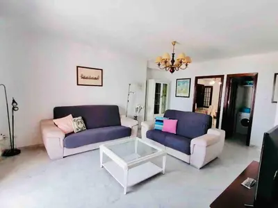 a living room with two couches and a coffee table at Mar Vendaval Grupo AC Gestion in Cádiz