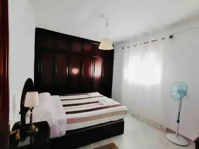a bedroom with a bed with a wooden headboard at Mar Vendaval Grupo AC Gestion in Cádiz