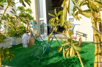 a blue chair sitting on a porch with plants at Puerto Sherry Boat in El Puerto de Santa María