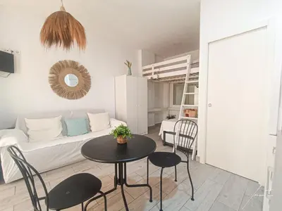 a living room with a table and a couch at Puerto Sherry Boat in El Puerto de Santa María