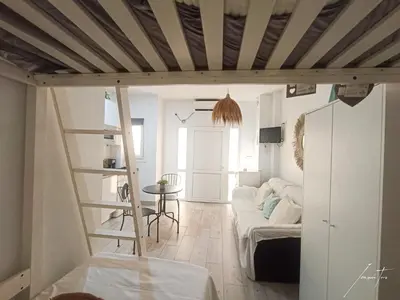 a living room with a loft bed and a table at Puerto Sherry Boat in El Puerto de Santa María