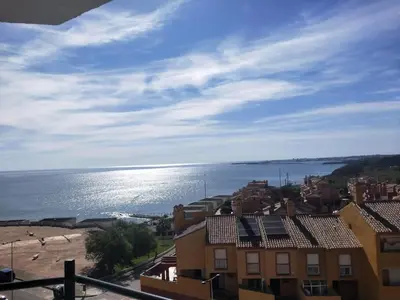a view of a beach and buildings and the ocean at Wehostcostaluz -Apartamento El Parador in El Puerto de Santa María