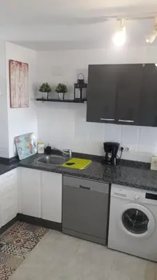 a kitchen with a sink and a washing machine at Wehostcostaluz -Apartamento El Parador in El Puerto de Santa María