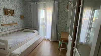 a small bedroom with a bed and a window at Sanlúcar Bajo de Guía PG Apartamentos in Sanlúcar de Barrameda