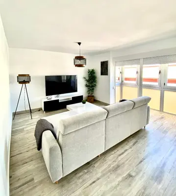 a living room with a couch and a television at Apartamento en el centro San Fernando Cadiz. in San Fernando