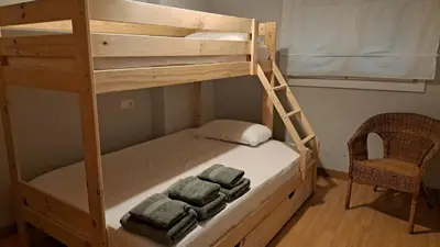 a bunk bed with two towels on the bottom bunk at Apartamento primera linea de playa reformado en Las Redes in El Puerto de Santa María