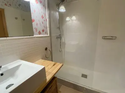 a bathroom with a white sink and a shower at Apartamento primera linea de playa reformado en Las Redes in El Puerto de Santa María