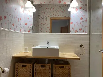 a bathroom with a sink and a mirror at Apartamento primera linea de playa reformado en Las Redes in El Puerto de Santa María