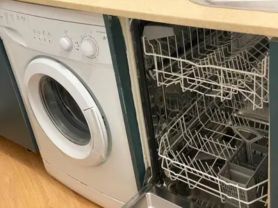 a washing machine with its door open in a kitchen at Apartamento primera linea de playa reformado en Las Redes in El Puerto de Santa María