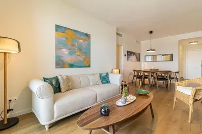 a living room with a couch and a table at Allo Apartments Bonald Parking Piscina 3 Habitaciones in Jerez de la Frontera