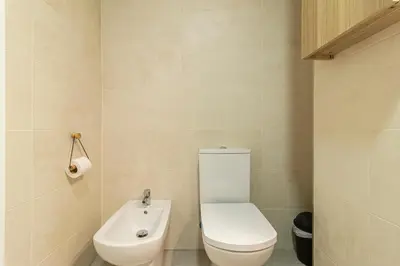a bathroom with a toilet and a sink at Allo Apartments Bonald Parking Piscina 3 Habitaciones in Jerez de la Frontera