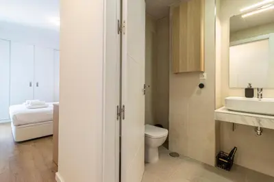 a bathroom with a toilet and a sink at Allo Apartments Bonald Parking Piscina 3 Habitaciones in Jerez de la Frontera