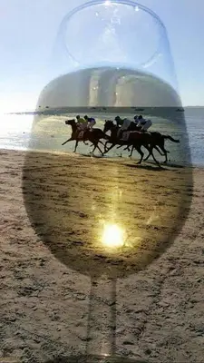 a group of horses running on a beach with a ball at Mirador de Sanlucar 6 in Sanlúcar de Barrameda