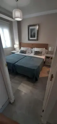 a bedroom with a large bed with a blue blanket at Mirador de Sanlucar 6 in Sanlúcar de Barrameda