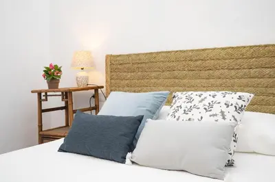a bedroom with a bed with pillows on it at La Casa 1832 Boutique in Sanlúcar de Barrameda