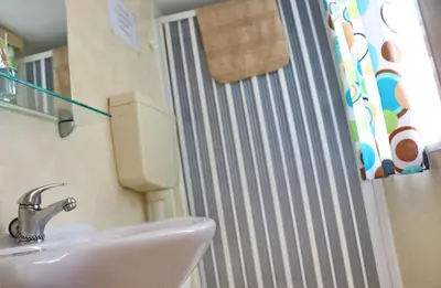 a bathroom with a sink and a shower at Bungalow Puntalejo in Conil de la Frontera