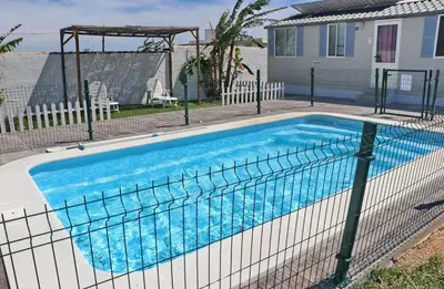 a swimming pool with a fence around it at Bungalow Puntalejo in Conil de la Frontera