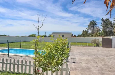 a swimming pool in a yard with a fence at Bungalow Puntalejo in Conil de la Frontera