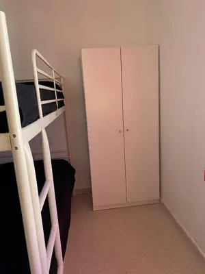 a bedroom with a bunk bed and a cabinet at Casa Ohana in Conil de la Frontera