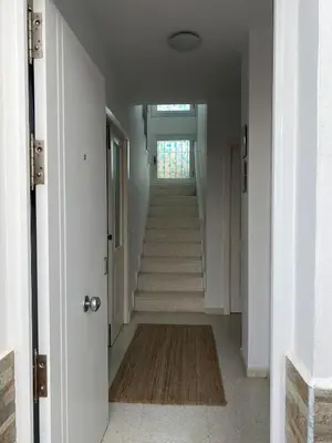 a hallway with stairs in a house at Casa Ohana in Conil de la Frontera