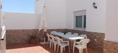 a dining room with a table and chairs at Casa Ohana in Conil de la Frontera