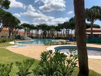 a pool at the resort with trees at Apartamento en la Barrosa in Chiclana de la Frontera