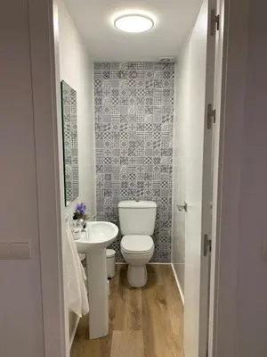 a bathroom with a toilet and a sink at Apartamento en la Barrosa in Chiclana de la Frontera