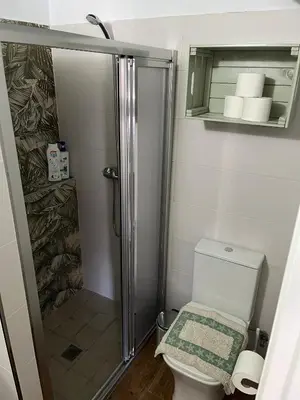 a small bathroom with a shower and a toilet at Casa Vladimir in Arcos de la Frontera