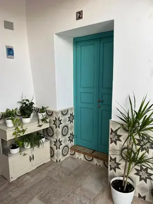 a blue door in a room with potted plants at Casa Vladimir in Arcos de la Frontera