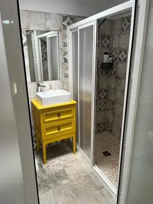 a bathroom with a sink and a shower with a mirror at Casa Vladimir in Arcos de la Frontera