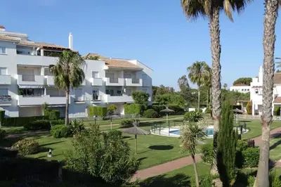 a view of a resort with palm trees at Ático Costa Ballena - Cádiz in Rota