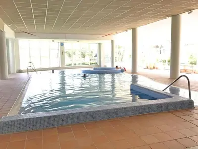 a large swimming pool in a large building at Ático Costa Ballena - Cádiz in Rota