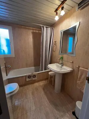 a bathroom with a sink and a tub and a toilet at Ático Costa Ballena - Cádiz in Rota